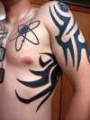 chest ribs and arm tattoo