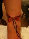 Ankle bow tattoo