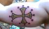 Toulouse Cross inner arm tattoo