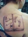 open book with my son name and baby footprints and our signs tattoo