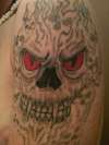 Demon surrounded skull tattoo