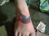 Sparrow on top of foot tattoo