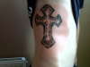 cross on ribs tattoo