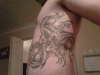 Triple Koi on ribs tattoo