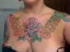 skull & flowers chest colored tattoo