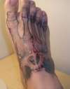 Foot tattoo, skull and bones