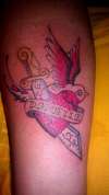 Sailor Jerry sparrow with sword in heart tattoo, by trickstattoo