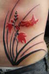 black with red flowers tattoo