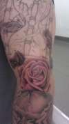 Rose shaded on outer elbow tattoo