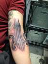 violin arm tattoo