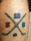 crossed hockey sticks with kids #'s tattoo