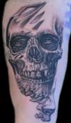 breaking skull tattoo