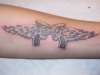 guns with wings tattoo