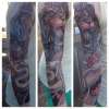 Lion fighting Snake Sleeve tattoo