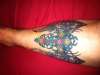 Tribal cross with wings tattoo