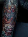 Evil clown & winged skull tattoo