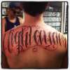 Freehand back tattoo lettering last name