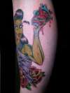 Zombie Girl holding hart (on left shin) tattoo