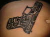 tribal gun tattoo