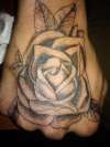 A black and white traditional rose tattoo