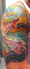 Left arm dragon half sleeve tattoo
