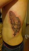 Praying hands on side tattoo