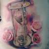 Flowers and hourglass tattoo