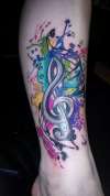 watercolor paint splatter trebble cleft tattoo