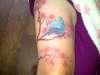 top of leg cherry blossom & bird tattoo