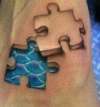 3D jigsaw pieces on foot tattoo