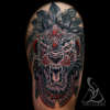 Erwins-black-grey-and-red-tribal-lion-thigh-tattoo-done-by-ben-l