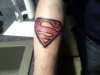 Superman emblem tattoo