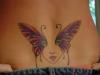 Butterfly face lower back tattoo