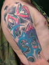 Swastika wave's and chrome Macintosh roses tattoo