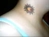 moon star inside of sun on neck tattoo