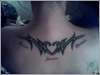 Tribal with my kids names under tattoo