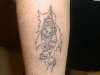 skulls ripin thru tattoo