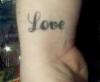 Love on right wrist tattoo