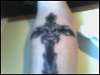 cross and skull on arm tattoo