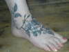 Black and grey roses foot tattoo