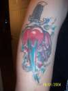 Pierced heart with skull tattoo