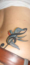 traditional swallow with treble clef tattoo