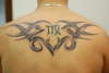 Tribal with virgo symbol tattoo