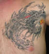 DRAGON HEAD ON CHEST tattoo