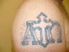 Alpha and Omega with cross tattoo