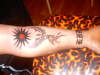 tribal sun, phoenix and old english tattoo