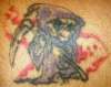 Grinnin Grim tattoo
