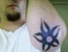 Tribal Star left elbow tattoo