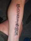 old english on side of leg tattoo