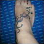 tribal flower on foot tattoo